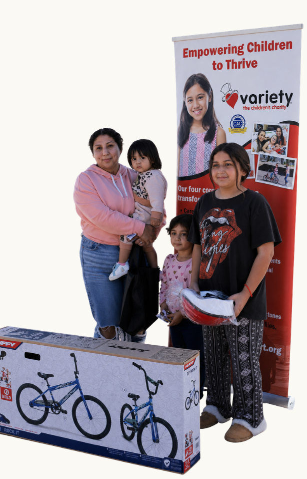 Family receiving a bicycle and safety equipment through Variety of the Desert.