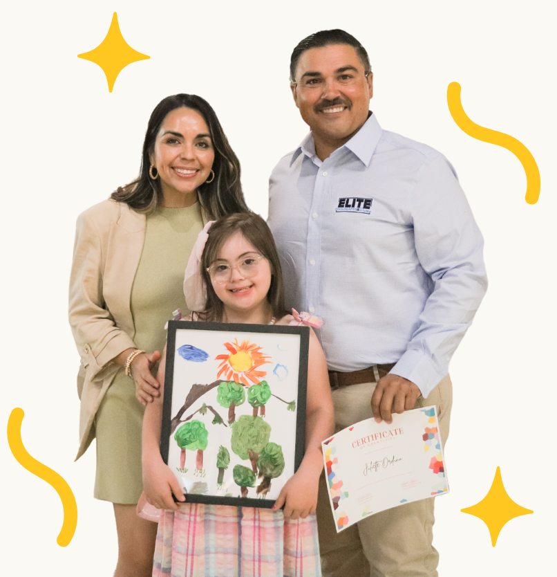 family-art-support.jpg Child holding artwork with her family at a Variety of the Desert event