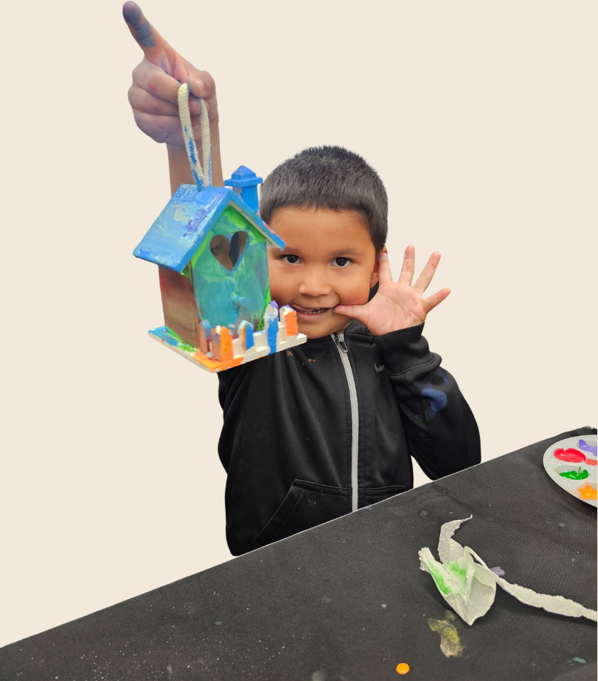 melissa-child-support.jpg Child proudly displaying a painted birdhouse created during a Variety of the Desert art program.